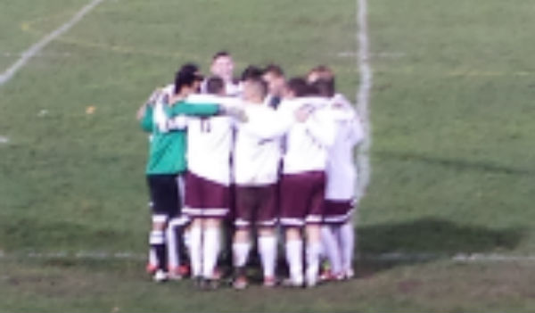 Senior boys cuddle before their second half on senior night.
