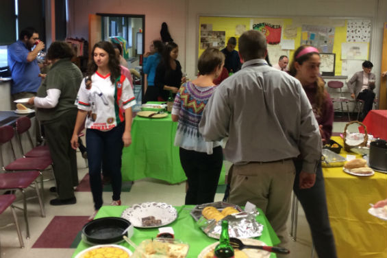 Students and teachers enjoy traditional Portuguese dishes at the event.