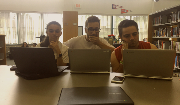 From left to right: sophomore Amanda Poirier, senior Matthew Goncalves, and senior Joe Banas use their newly issued Chromebooks in the Ludlow High School library.