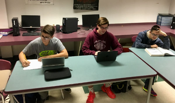 From left to right: Senior Nathan Navarro, sophomore Donald Gregory, and sophomore Sebastian Biegaj do school work in Mr. Cangemi's third period DLT. 