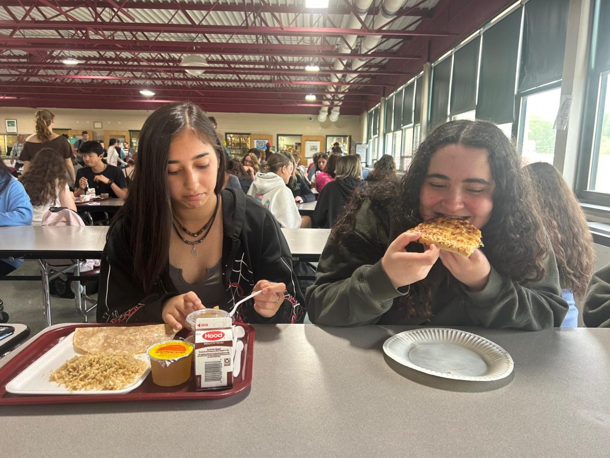 Juniors Hayden Delrosario Rodrigues (left) and Emilia Alves consume some "nutrition" in the LHS cafeteria. 