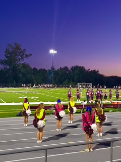 The cheerleaders face the game decked out in cute neon attire
Edited by: Amanda Miller